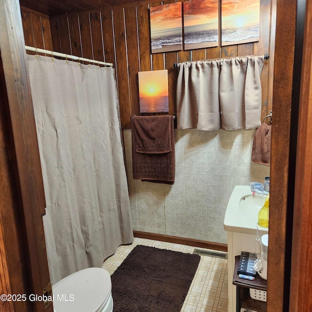 1948 Leo Ave, Rotterdam, NY 12306 - bathroom featuring vanity, toilet, a shower with shower curtain, and wood walls