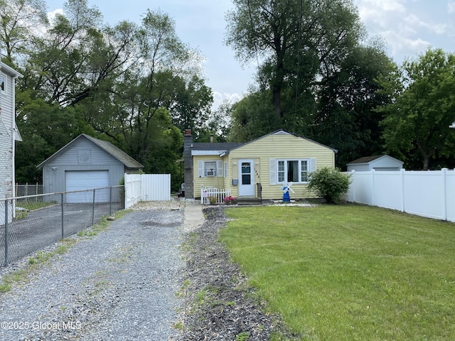 1948 Leo Ave, Rotterdam, NY 12306 - view of front of property with asphalt driveway, an outbuilding, a garage, and a chimney
