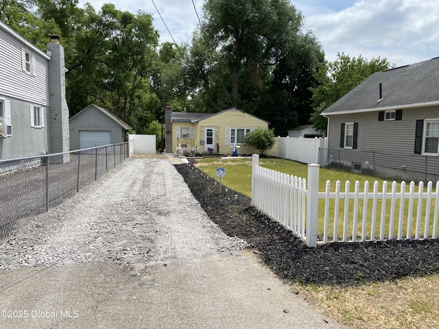 1948 Leo Ave, Rotterdam, NY 12306 - view of yard featuring a detached garage, an outbuilding, and view of scattered trees