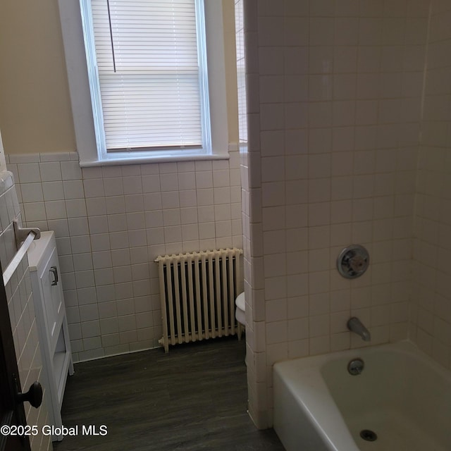 359 2nd Ave, Albany, NY 12209 - bathroom with radiator, tile walls, wood finished floors, shower / bath combination, and a wainscoted wall