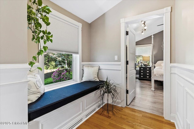 17 Cypress Pt, Clifton Park, NY 12065 - living area with light wood-style floors, vaulted ceiling, and a wainscoted wall