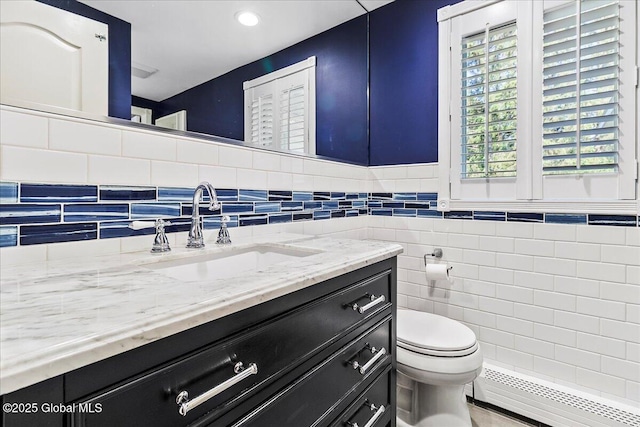 17 Cypress Pt, Clifton Park, NY 12065 - bathroom featuring a baseboard heating unit, vanity, tile walls, and recessed lighting
