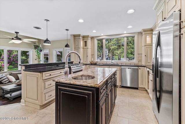 17 Cypress Pt, Clifton Park, NY 12065 - kitchen featuring cream cabinets, stainless steel appliances, healthy amount of natural light, an island with sink, and recessed lighting