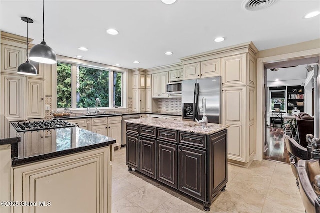 17 Cypress Pt, Clifton Park, NY 12065 - kitchen with cream cabinets, stainless steel appliances, dark stone countertops, decorative backsplash, and recessed lighting