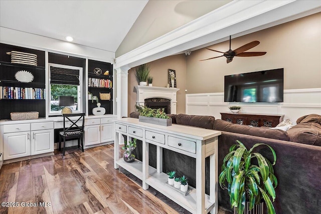 17 Cypress Pt, Clifton Park, NY 12065 - living area with lofted ceiling, a fireplace, a ceiling fan, wood finished floors, and a wainscoted wall