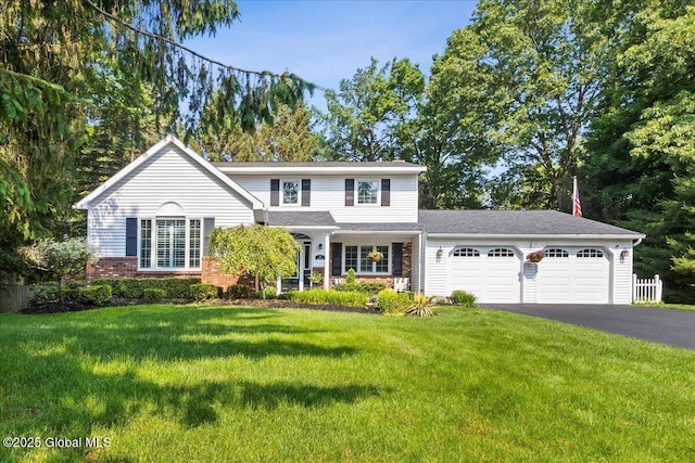 17 Cypress Pt, Clifton Park, NY 12065 - traditional home featuring a garage, asphalt driveway, a front lawn, and brick siding