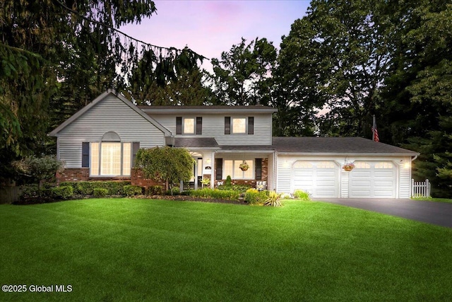 17 Cypress Pt, Clifton Park, NY 12065 - traditional home featuring asphalt driveway, an attached garage, a front yard, and brick siding