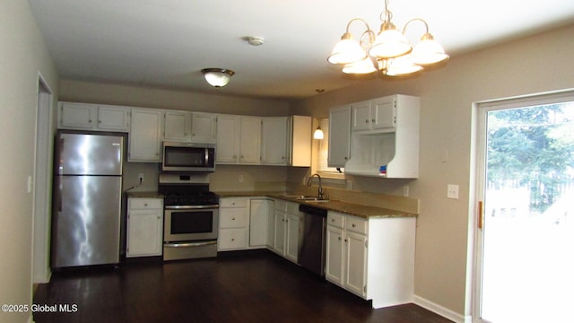 8 Cloverleaf Dr, Warrensburg, NY 12885 - kitchen featuring stainless steel appliances, a chandelier, a sink, and white cabinetry