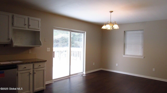 8 Cloverleaf Dr, Warrensburg, NY 12885 - unfurnished dining area with dark wood-style flooring, a chandelier, and baseboards
