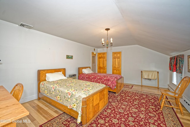 805 Karenwald Ln, Schenectady, NY 12309 - bedroom featuring light wood finished floors, lofted ceiling, a chandelier, and baseboard heating