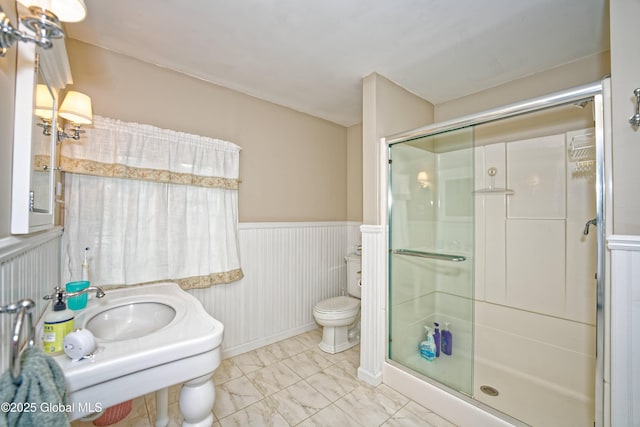 805 Karenwald Ln, Schenectady, NY 12309 - bathroom featuring a shower stall, marble look tile flooring, and a wainscoted wall