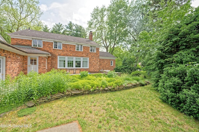 805 Karenwald Ln, Schenectady, NY 12309 - view of front of house featuring a chimney, brick siding, and a front yard