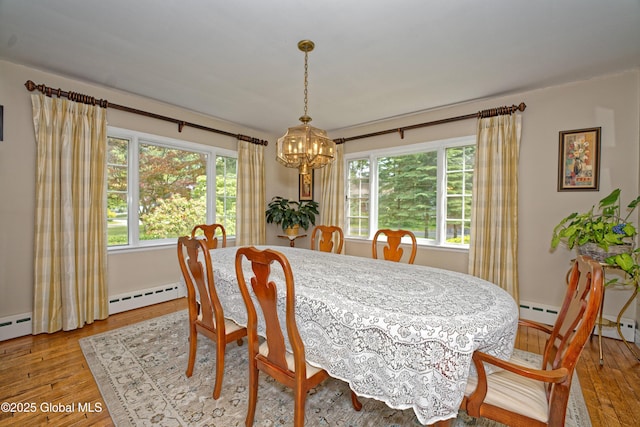 805 Karenwald Ln, Schenectady, NY 12309 - dining space with a chandelier, a baseboard heating unit, and hardwood / wood-style flooring