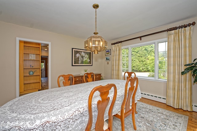 805 Karenwald Ln, Schenectady, NY 12309 - dining room with baseboard heating, a chandelier, and wood finished floors