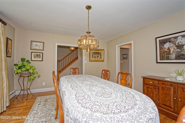 805 Karenwald Ln, Schenectady, NY 12309 - dining space with light wood-type flooring, a chandelier, stairway, and baseboard heating
