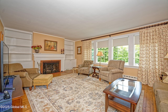 805 Karenwald Ln, Schenectady, NY 12309 - living room with a baseboard heating unit, hardwood / wood-style floors, a brick fireplace, and ornamental molding