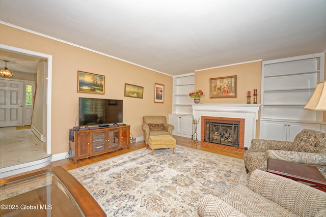 805 Karenwald Ln, Schenectady, NY 12309 - living room featuring ornamental molding, built in shelves, a brick fireplace, and wood finished floors