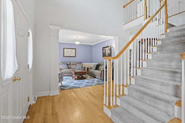 41 Jean Pl, Guilderland, NY 12303 - foyer with stairs, crown molding, wood finished floors, and ornate columns