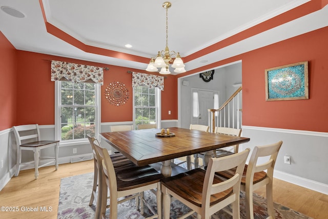 41 Jean Pl, Guilderland, NY 12303 - dining room featuring a chandelier, light wood finished floors, crown molding, a raised ceiling, and stairs