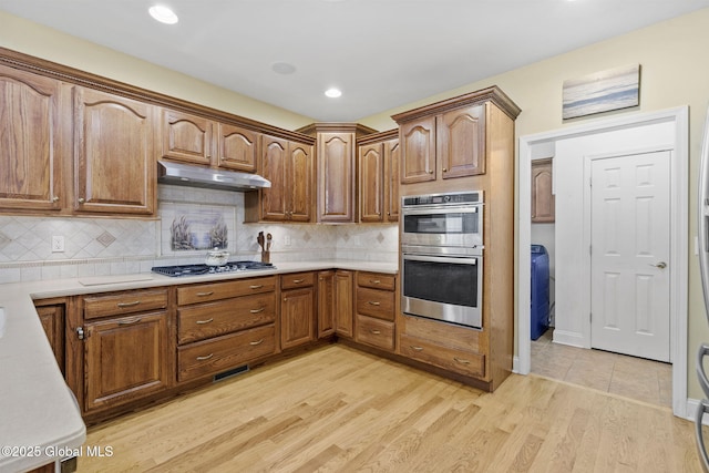 41 Jean Pl, Guilderland, NY 12303 - kitchen featuring stainless steel appliances, under cabinet range hood, light wood-type flooring, light countertops, and recessed lighting