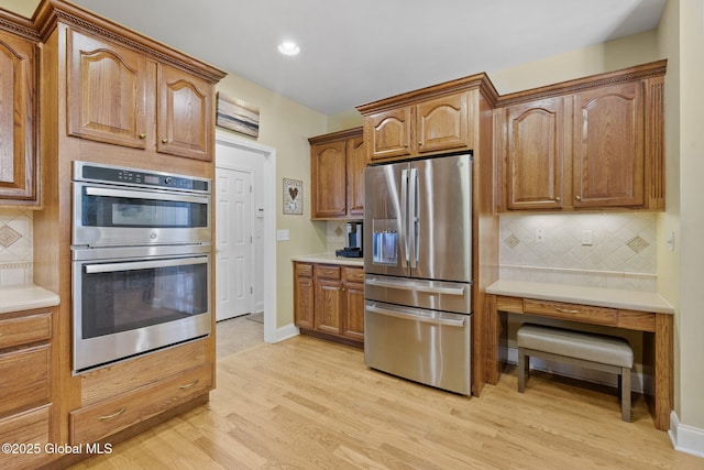 41 Jean Pl, Guilderland, NY 12303 - kitchen featuring stainless steel appliances, light wood-style floors, tasteful backsplash, light countertops, and recessed lighting