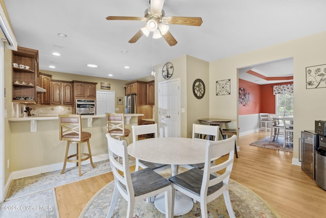 41 Jean Pl, Guilderland, NY 12303 - dining room featuring light wood-style floors, ceiling fan, recessed lighting, and a tray ceiling