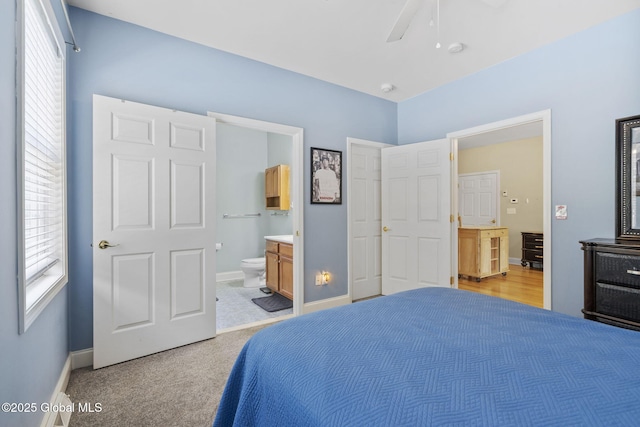 41 Jean Pl, Guilderland, NY 12303 - bedroom with multiple windows, ensuite bathroom, light carpet, and a ceiling fan