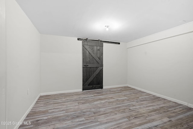 41 Jean Pl, Guilderland, NY 12303 - unfurnished room with a barn door and wood finished floors