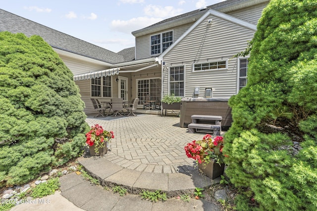 41 Jean Pl, Guilderland, NY 12303 - back of house with a patio, a hot tub, outdoor dining space, and a shingled roof