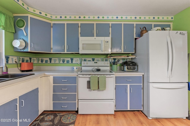 22 Sylvan Ct, Clifton Park, NY 12065 - kitchen with white appliances, blue cabinetry, light wood-type flooring, and light countertops