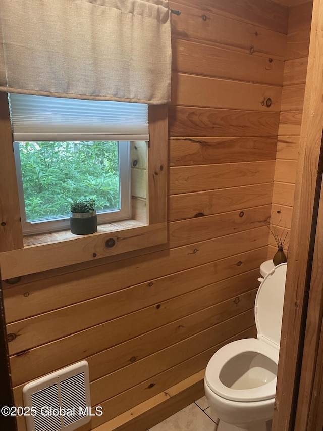 1469 S Shore Rd, Hadley, NY 12835 - bathroom with wood walls, toilet, tile patterned flooring, and heating unit