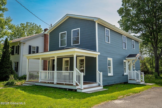 11 N Park St, White Creek, NY 12816 - view of front of property featuring a porch, a front yard, and a chimney