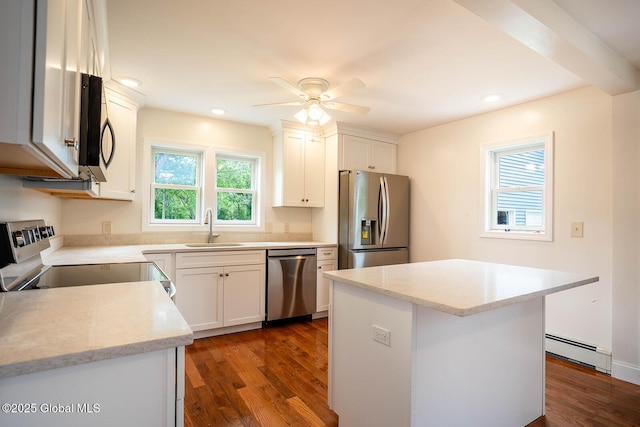 11 N Park St, White Creek, NY 12816 - kitchen with appliances with stainless steel finishes, a baseboard radiator, a sink, dark wood-style flooring, and ceiling fan