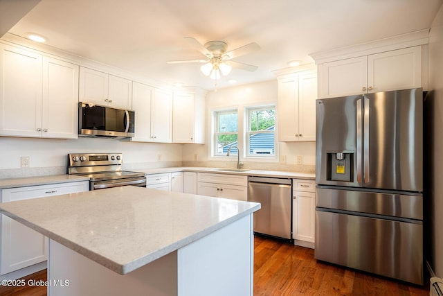 11 N Park St, White Creek, NY 12816 - kitchen with stainless steel appliances, a sink, white cabinetry, recessed lighting, and ceiling fan