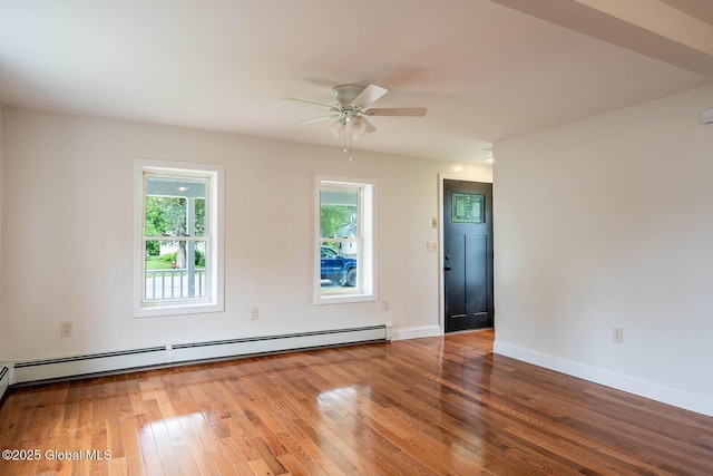 11 N Park St, White Creek, NY 12816 - empty room featuring a baseboard heating unit, hardwood / wood-style flooring, a ceiling fan, and baseboards