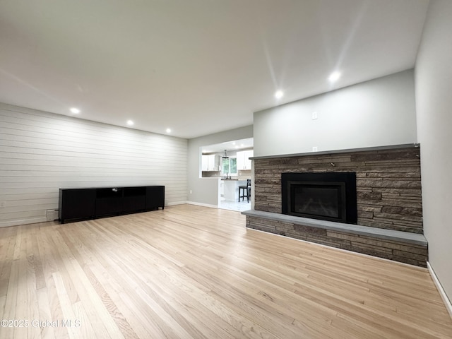 10 Kasper Dr, Colonie, NY 12211 - unfurnished living room with a stone fireplace, wood finished floors, recessed lighting, and baseboards