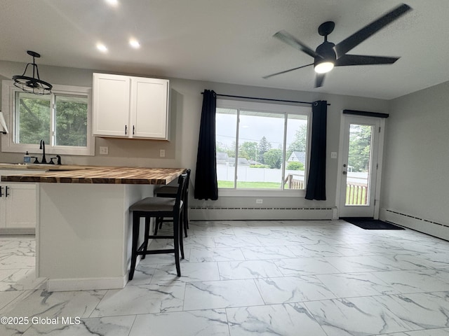 10 Kasper Dr, Colonie, NY 12211 - kitchen with butcher block counters, light marble finish floors, baseboard heating, plenty of natural light, and recessed lighting