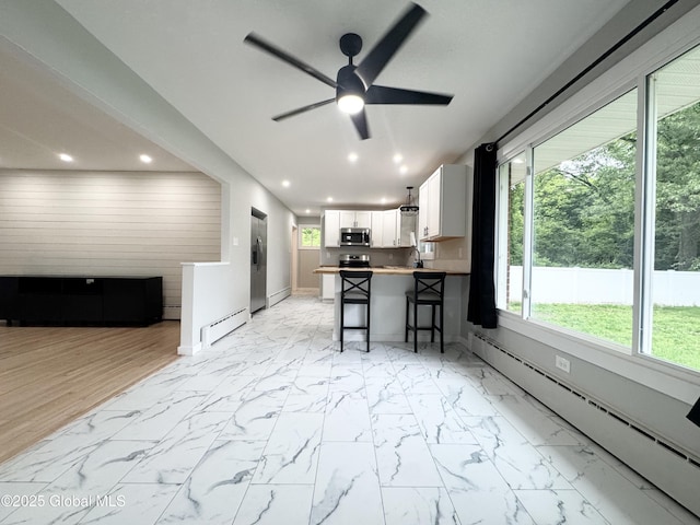 10 Kasper Dr, Colonie, NY 12211 - kitchen with appliances with stainless steel finishes, a baseboard radiator, open floor plan, baseboards, and recessed lighting