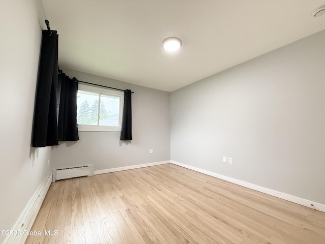 10 Kasper Dr, Colonie, NY 12211 - empty room with a baseboard radiator, light wood-style floors, and baseboards