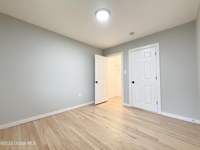 10 Kasper Dr, Colonie, NY 12211 - unfurnished bedroom featuring baseboards, light wood-style flooring, and a closet
