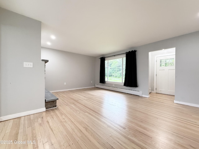10 Kasper Dr, Colonie, NY 12211 - unfurnished living room with baseboard heating, light wood-style flooring, baseboards, and recessed lighting