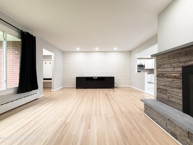 10 Kasper Dr, Colonie, NY 12211 - unfurnished living room with light wood-type flooring, recessed lighting, baseboards, and a baseboard radiator