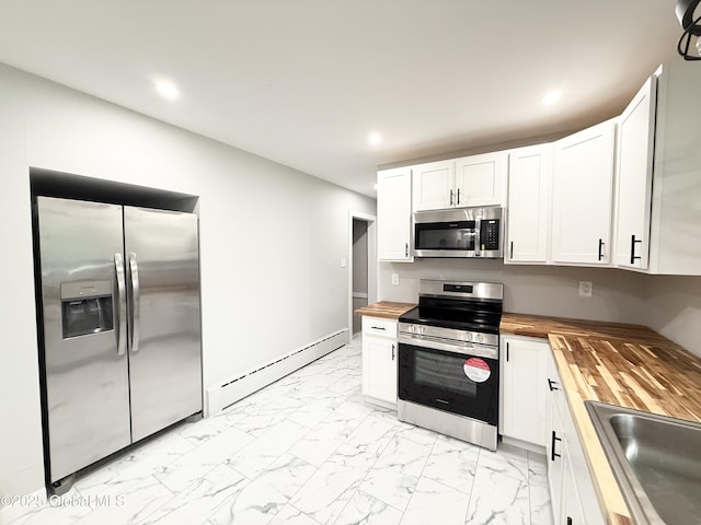 10 Kasper Dr, Colonie, NY 12211 - kitchen with butcher block counters, appliances with stainless steel finishes, a baseboard heating unit, light marble finish floors, and a sink