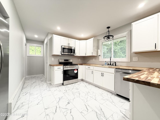 10 Kasper Dr, Colonie, NY 12211 - kitchen featuring stainless steel appliances, butcher block counters, recessed lighting, baseboards, and light marble finish flooring