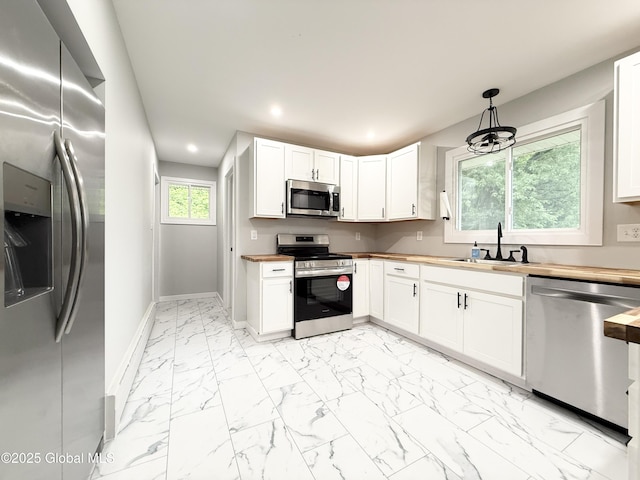10 Kasper Dr, Colonie, NY 12211 - kitchen featuring appliances with stainless steel finishes, a sink, wooden counters, light marble finish floors, and recessed lighting