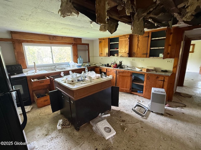 116 Coons Rd, Middleburgh, NY 12122 - kitchen with open shelves, brown cabinetry, a center island, and light countertops