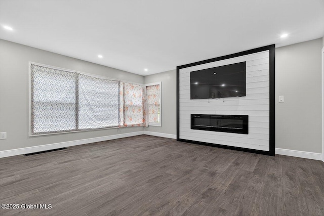 12 Haviland Ave, Glens Falls, NY 12801 - unfurnished living room featuring dark wood-style floors, baseboards, recessed lighting, and a large fireplace