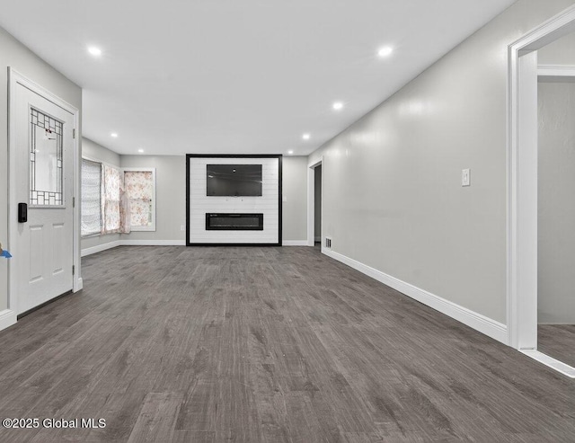 12 Haviland Ave, Glens Falls, NY 12801 - unfurnished living room with dark wood-style floors, baseboards, recessed lighting, and a large fireplace