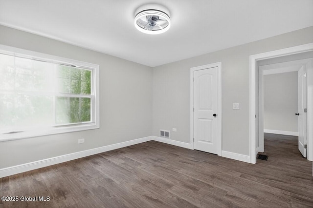 12 Haviland Ave, Glens Falls, NY 12801 - unfurnished bedroom featuring dark wood-type flooring and baseboards