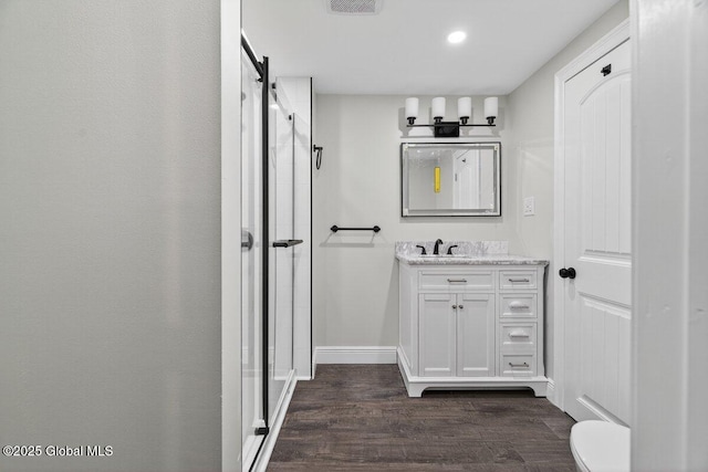 12 Haviland Ave, Glens Falls, NY 12801 - full bathroom featuring a stall shower, vanity, wood finished floors, toilet, and recessed lighting